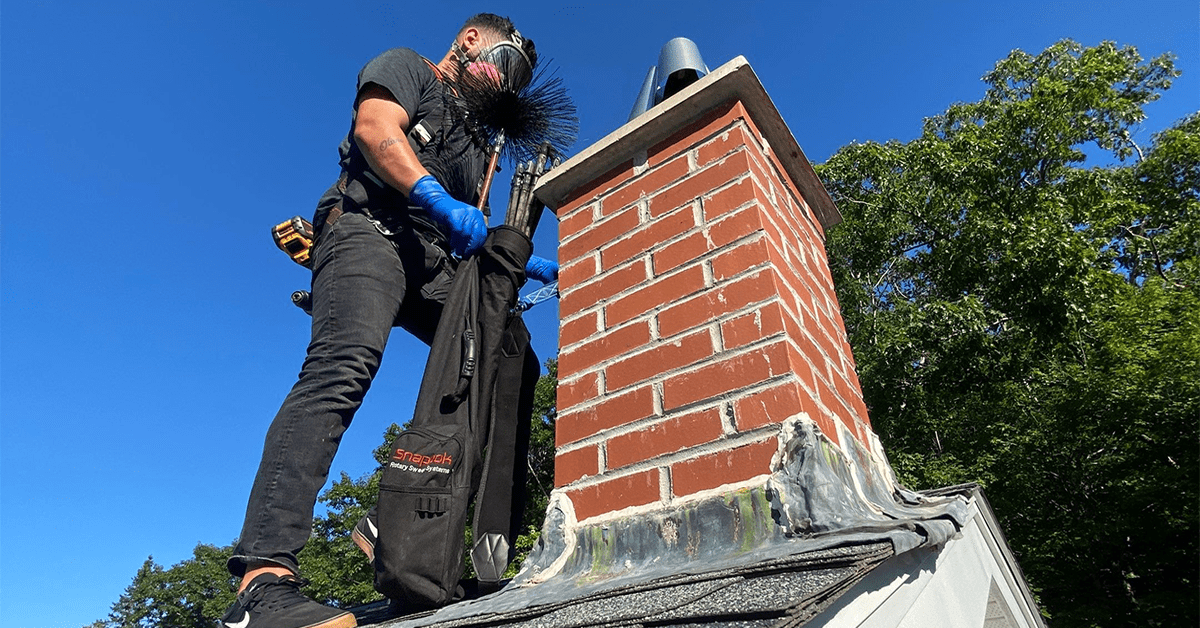 Exterior chimney assessment performed from a residential roof